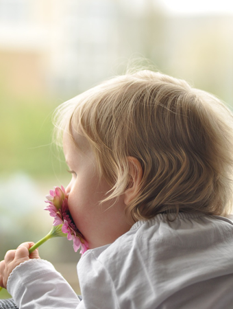 Child Smelling a flower